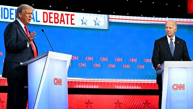 Donald Trump and Joe Biden stand behind podiums during the presidential debate on CNN.